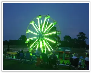 Ferris wheel illuminated green for HiRoad at night