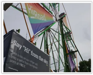 Upward view of HiRoad banners and green branded Ferris wheel panels