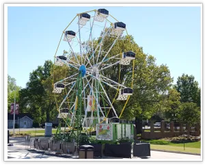 Taylor Swift NOW-branded Ferris wheel set up at an outdoor event
