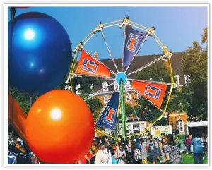 Orange and blue balloons framing the branded University of Illinois Ferris wheel