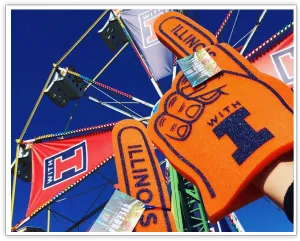 Orange Illinois foam finger held in front of the branded Ferris wheel