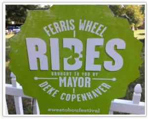 Westobou Festival Ferris wheel rides sign featuring Mayor Deke Copenhaver