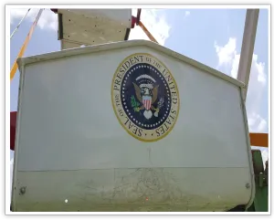 Presidential seal displayed on a white Ferris wheel gondola