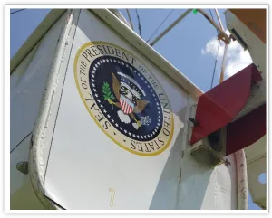 Angled close-up of a Ferris wheel gondola branded with the presidential seal