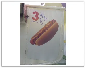 Close-up of a Ferris wheel gondola wrapped with Gwaltney hot dog artwork